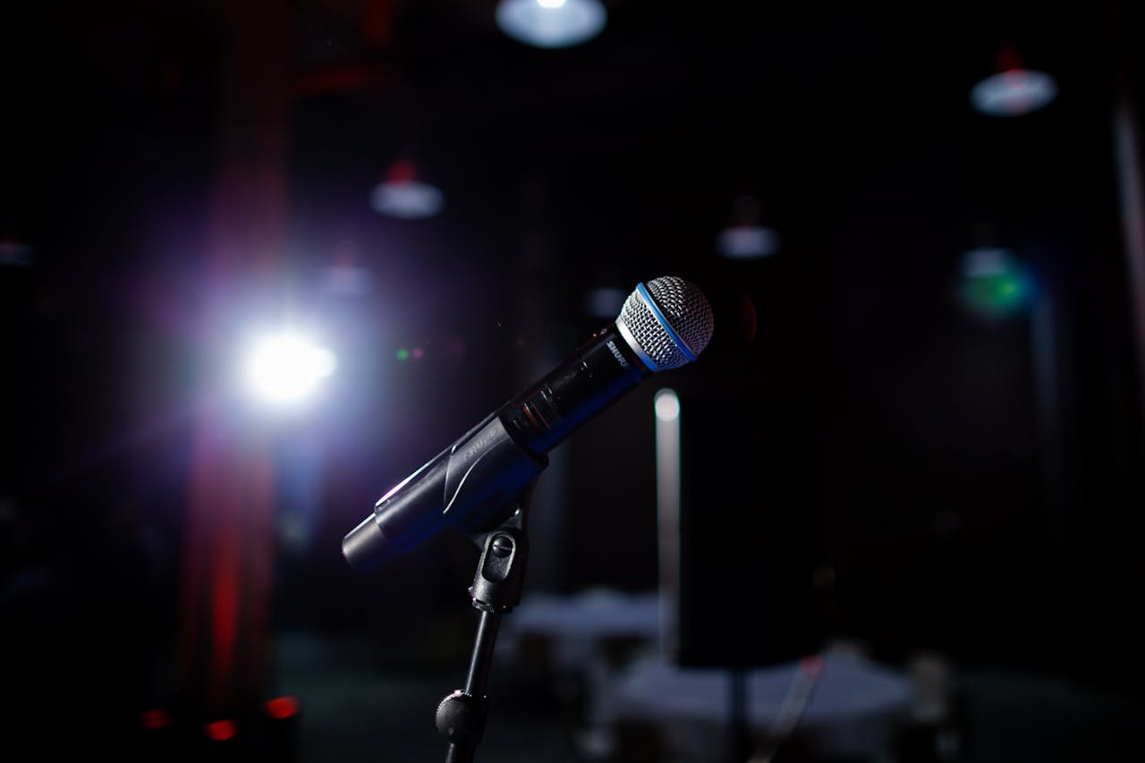 Microphone on a stage with spotlight, perfect for performance and public speaking themes.